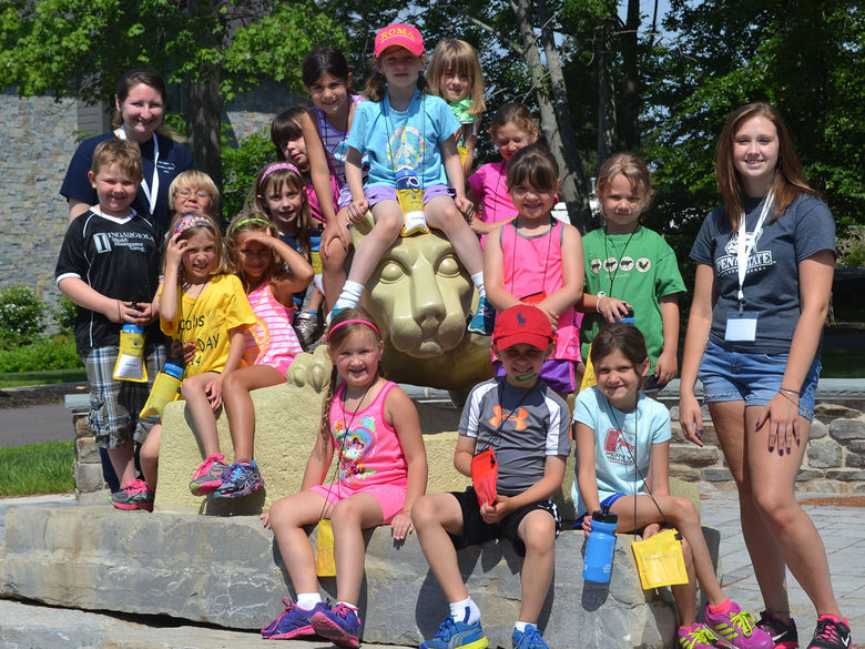 Group of children next to Nittany Lion statue