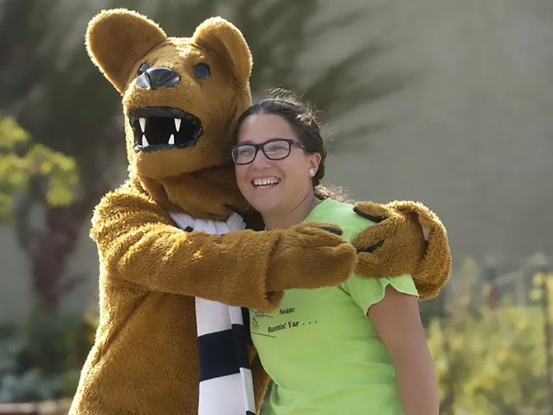 Nittany Lion mascot hugging a female student